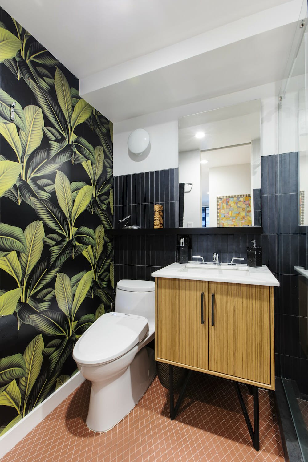 bathroom with leaf wallpaper black wall tile and orange floor tile