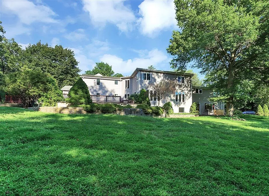 Before outdoor upgrades showing empty grassy backyard