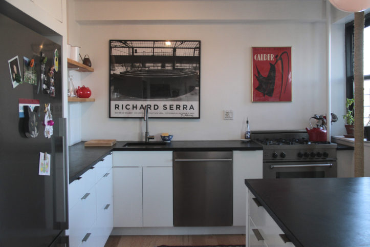 kitchen with white cabinets and black countertop and stainless steel appliances after renovation