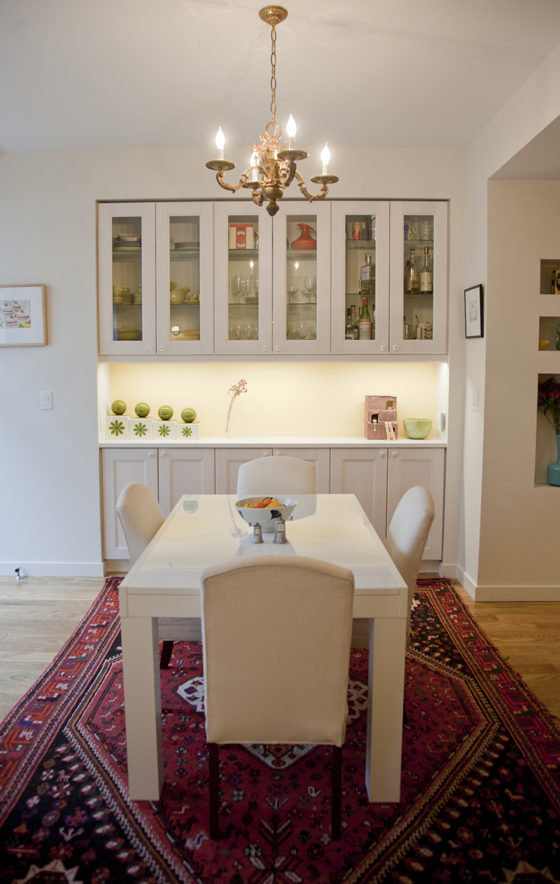 dining room with chandelier and built in butler pantry and hardwood floors after renovation