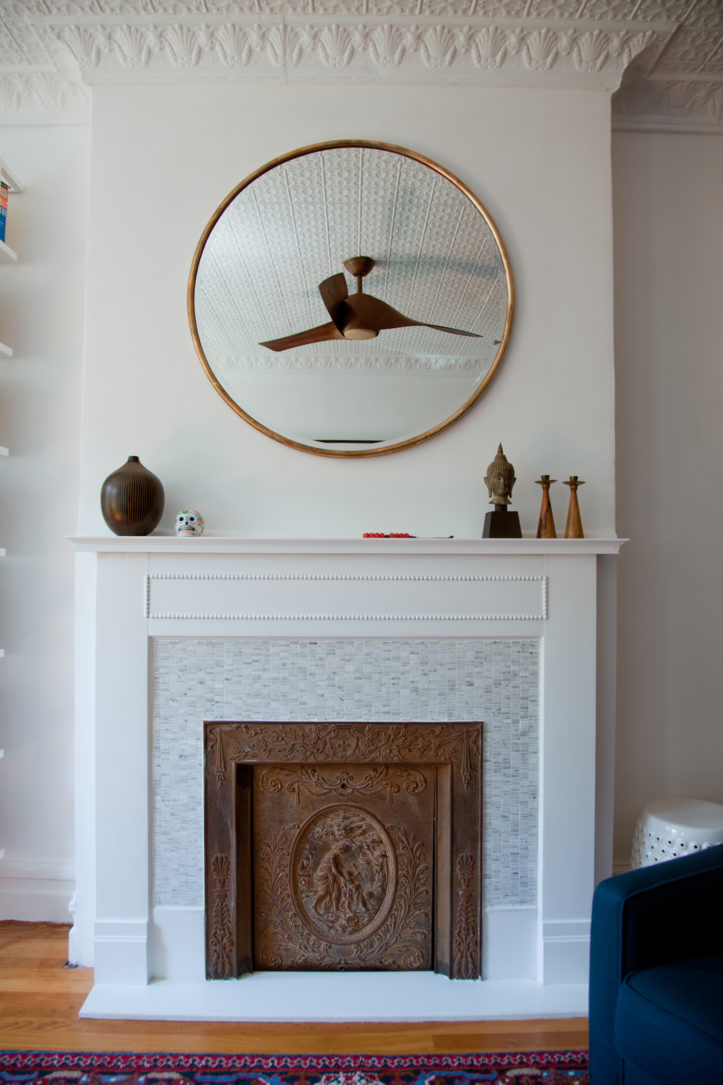 white fireplace with wood door and mantel and hardwood floors and crown molding after renovation