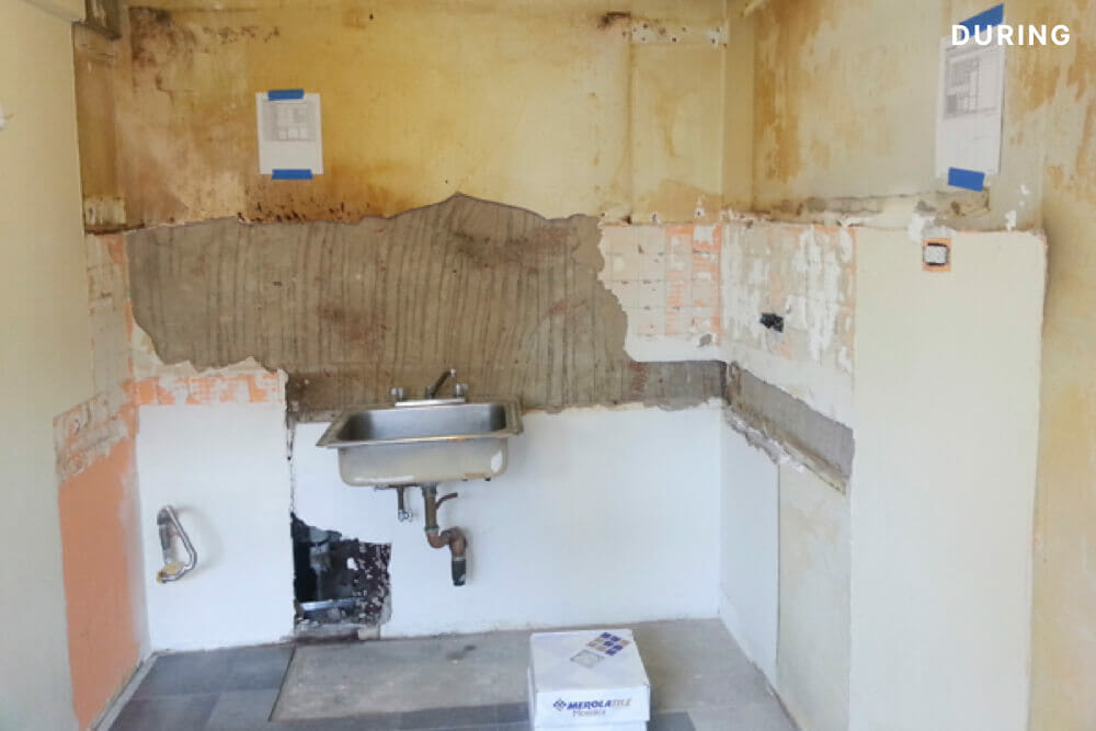 demolished kitchen with only sink remaining during renovation