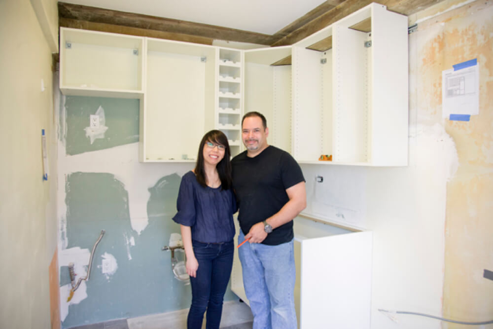lisa with her husband standing in their kitchen during renovation