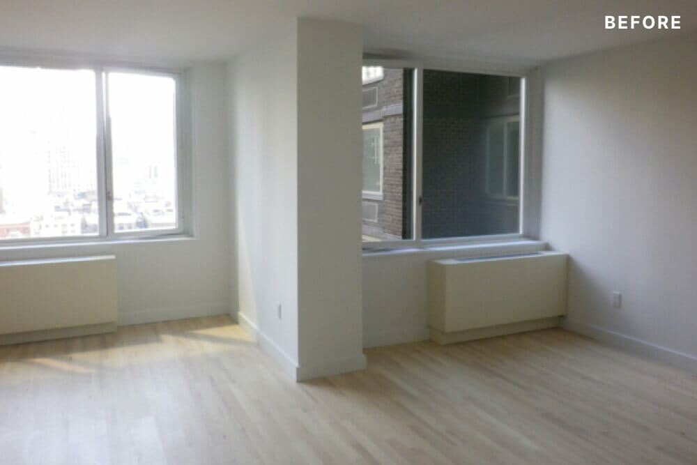 room with windows and hardwood floors of apartment before renovation