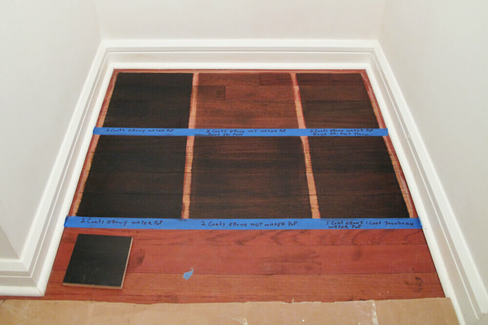 staining hardwood and creating pattern with tapes in a nook during renovation