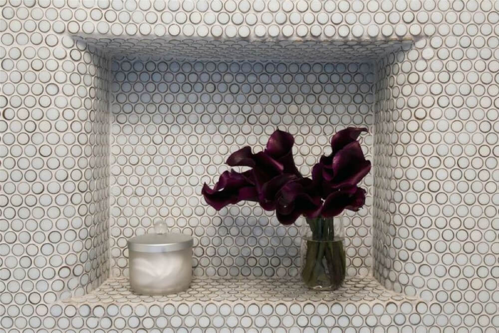 recessed bathroom shelf with patterned wall design after renovation