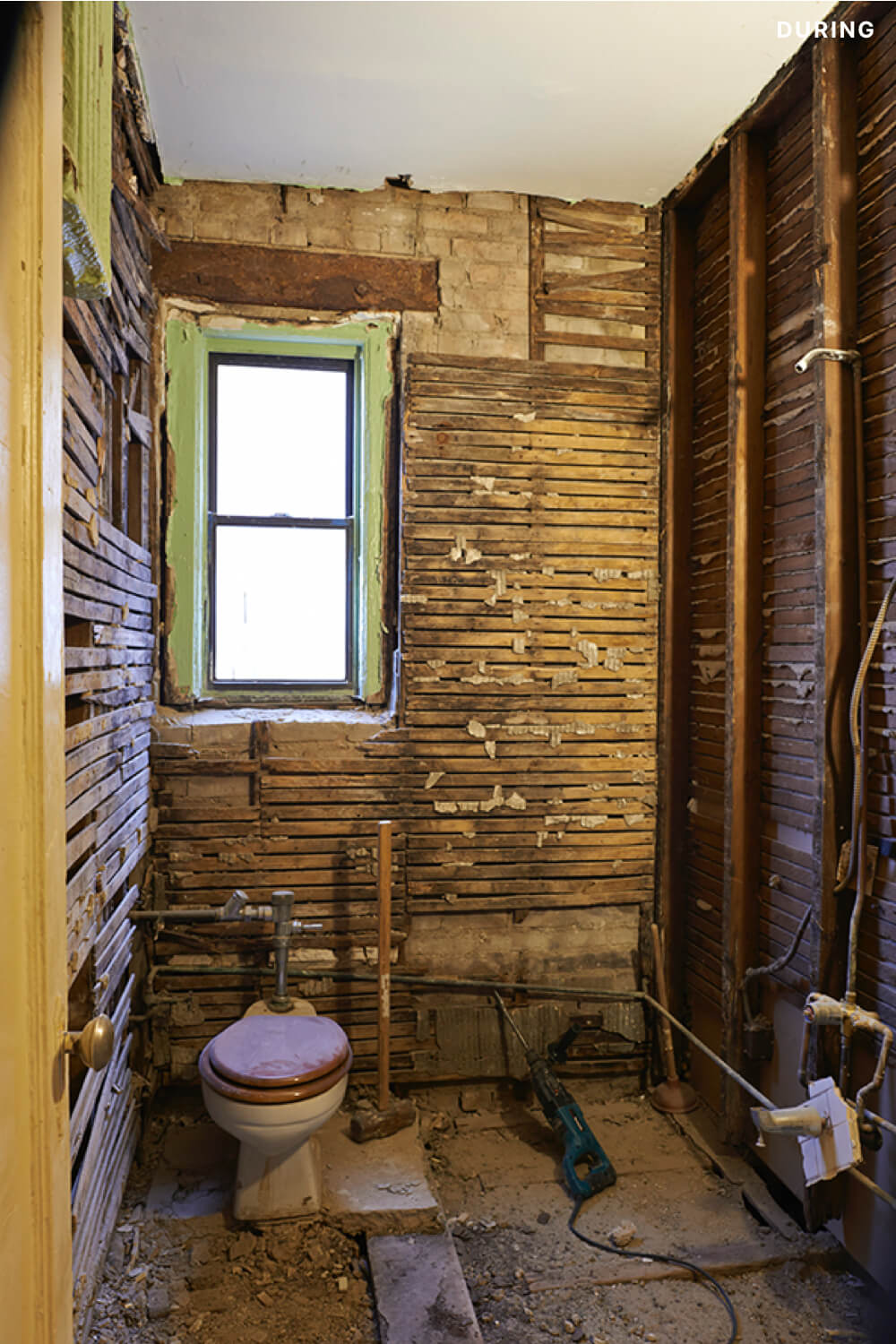 image of demolished bathroom with only toilet remaining during renovation