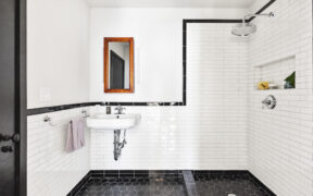 Black and white bathroom with hex flooring and white subway wall tile