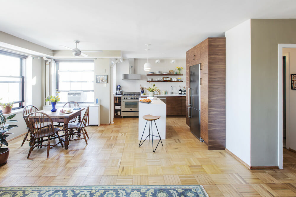 kitchen living and dining in one stock with parquet flooring and windows after renovation