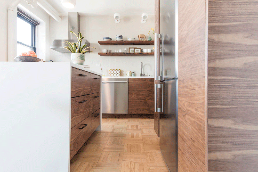 wooden kitchen cabinets with stainless steel appliances and parquet flooring and cabinets around refrigerator after renovation