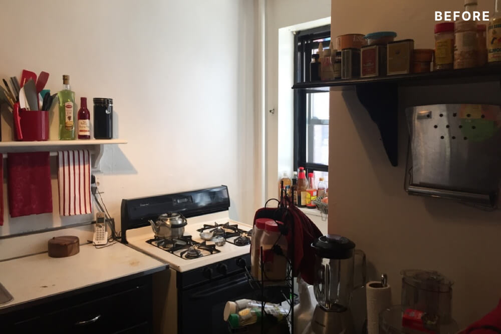small kitchen with floating shelves and gas cooking range before renovation