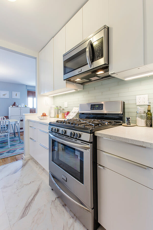 stainless steel appliances and white lacquered cabinets