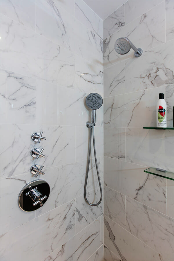 sleek showerheads and marble tiles