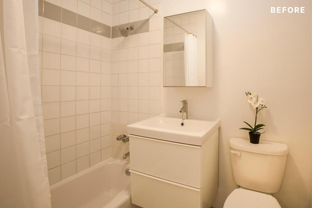 White bathroom with sink and vanity over a mirrored medicine cabinet before renovation