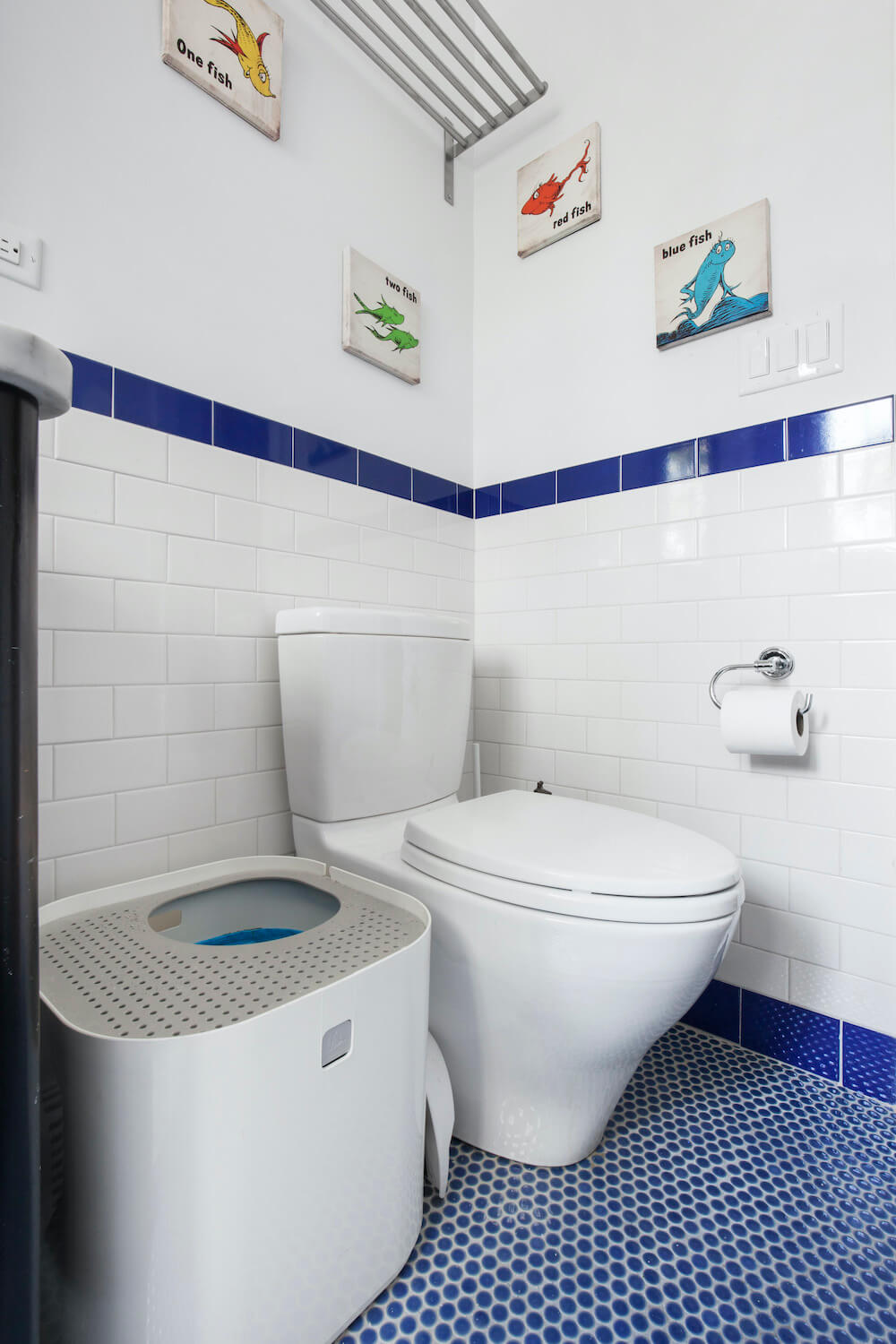 Blue penny round tiles with gray grouting along with white subway tiles after renovation 