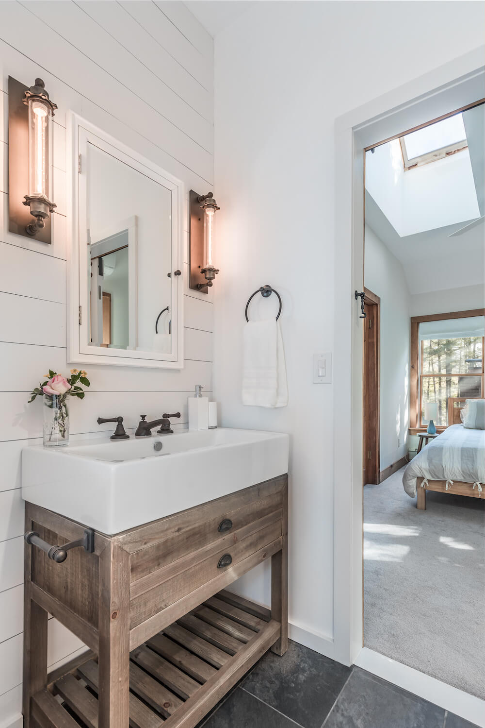 White farmhouse sink over wooden vanity Riverhead bathroom remodel