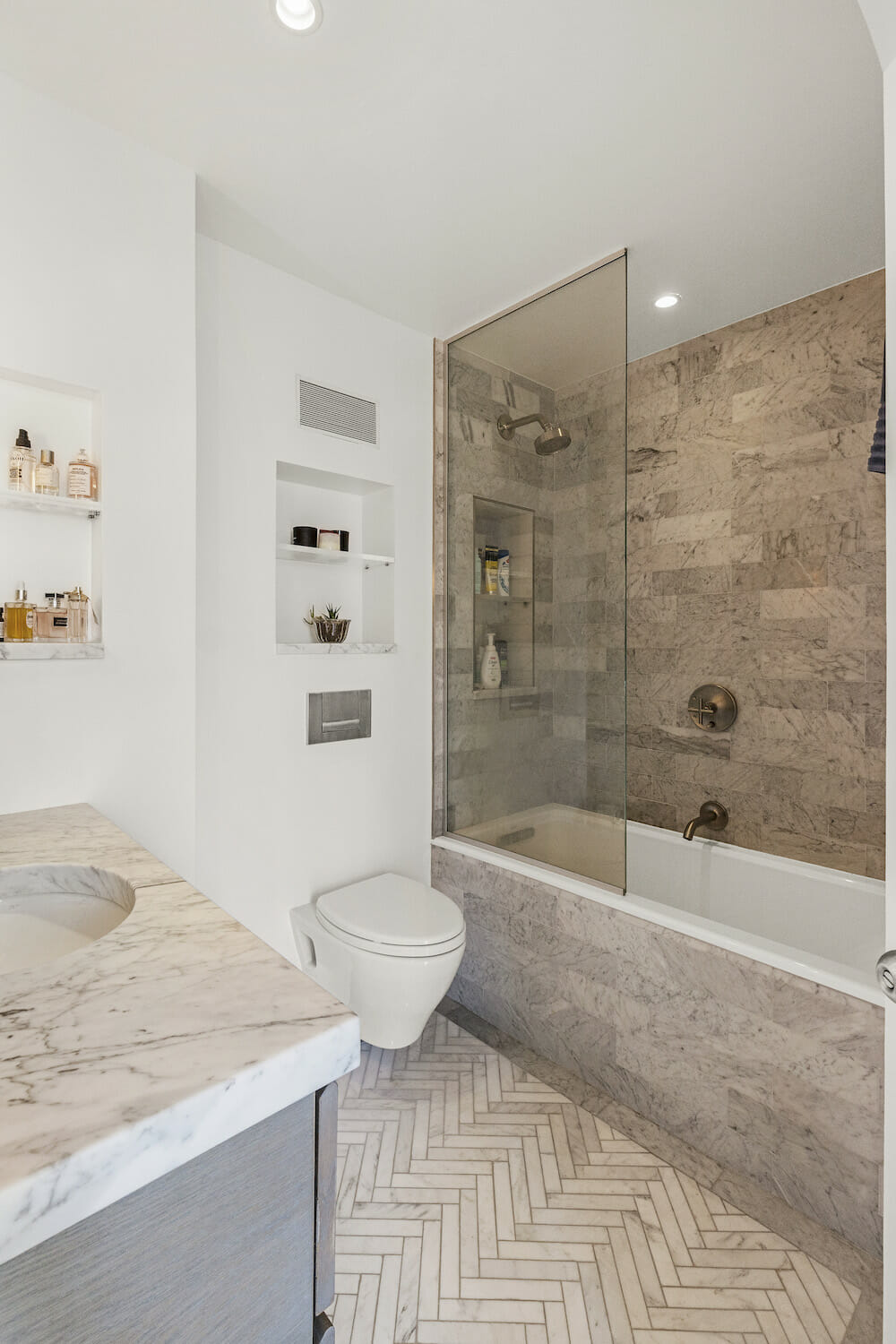 Bathroom with soaking tub herringbone marble floor tile