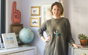 happy homeowner in a gray room after renovation