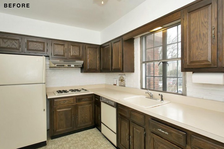 white countertop with brown kitchen cabinets and gray panelled glass window before renovation