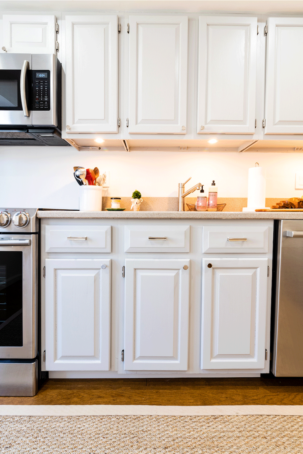 white panelled kitchen closed cabinets near appliances after renovation 