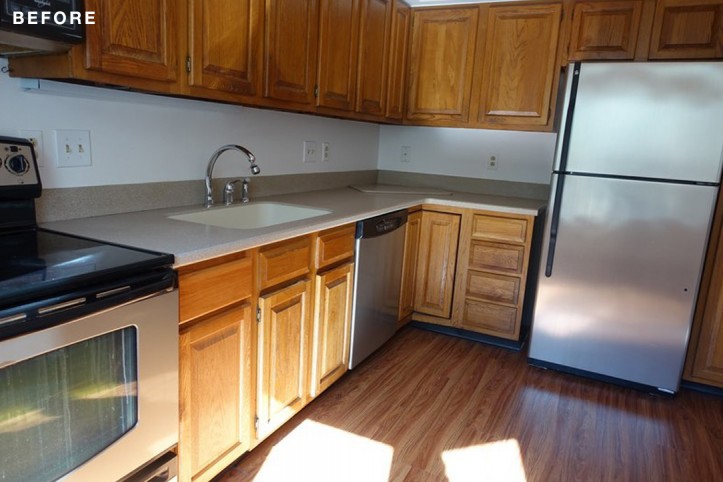 white countertop with dark wood panelled cabinets before renovation