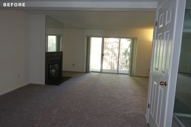 empty gray carpeted living room with french windows before renovation
