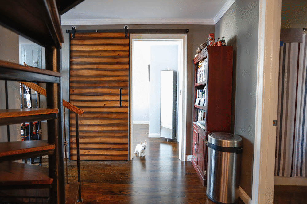 dark brown floor and brown door and a staircase