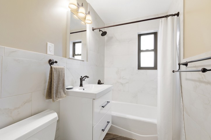 renovation, queens co-op, bathroom, floating sink cabinet, marble tile, herringbone tile