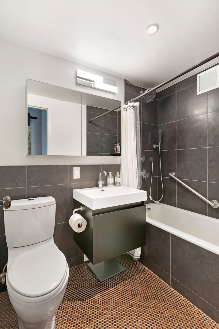 apartment renovation, clinton hill co-op, bathroom, large-format tiles, vinyl tub, bronze penny floor tile