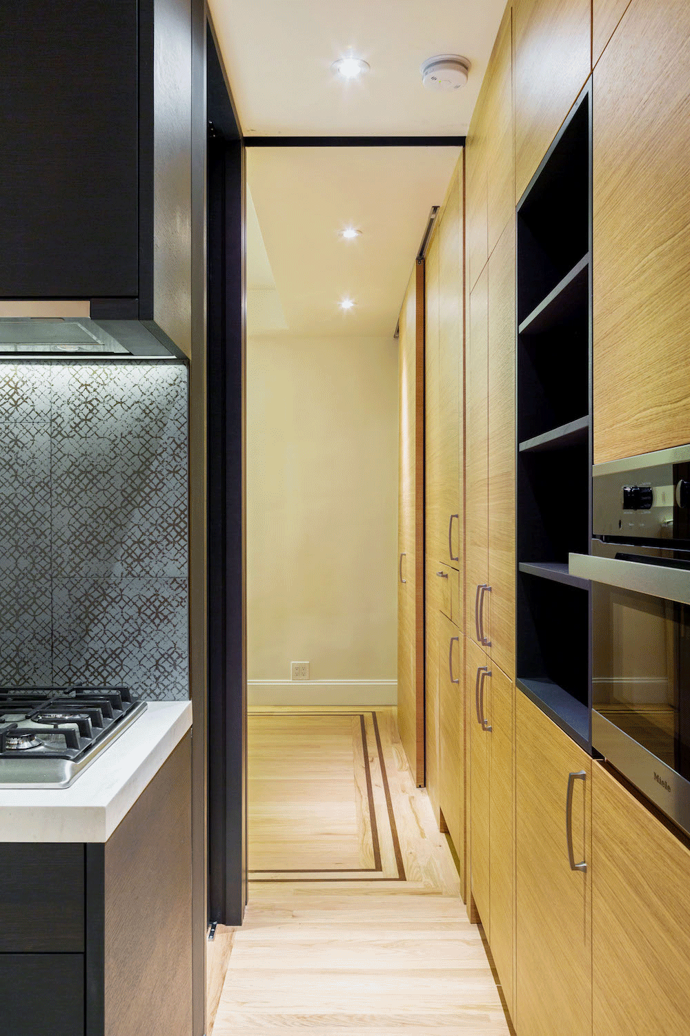 wood veneer custom cabinets in kitchen and bedroom after renovation