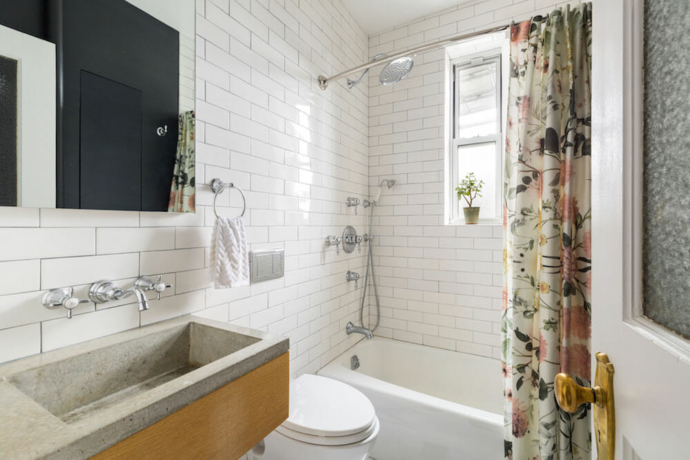 Image of bathroom with bathtub and concrete counters