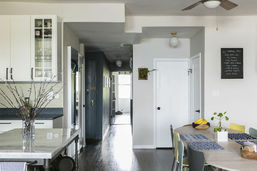 gray and white open kitchen with breakfast nook after renovation