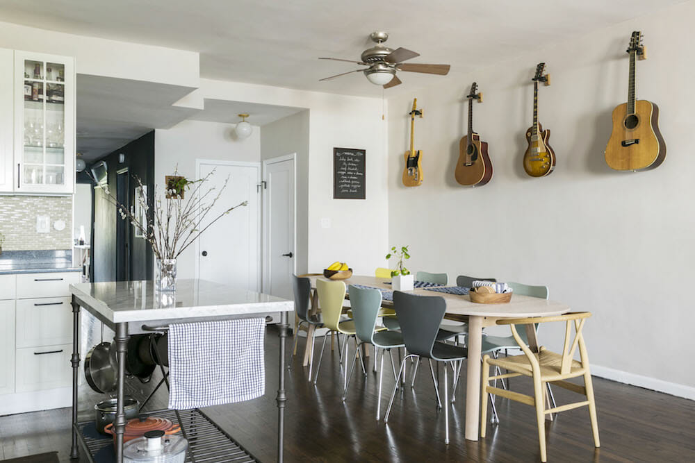 guitars mounted on white wall in a breakfast nook in the open kitchen after renovation