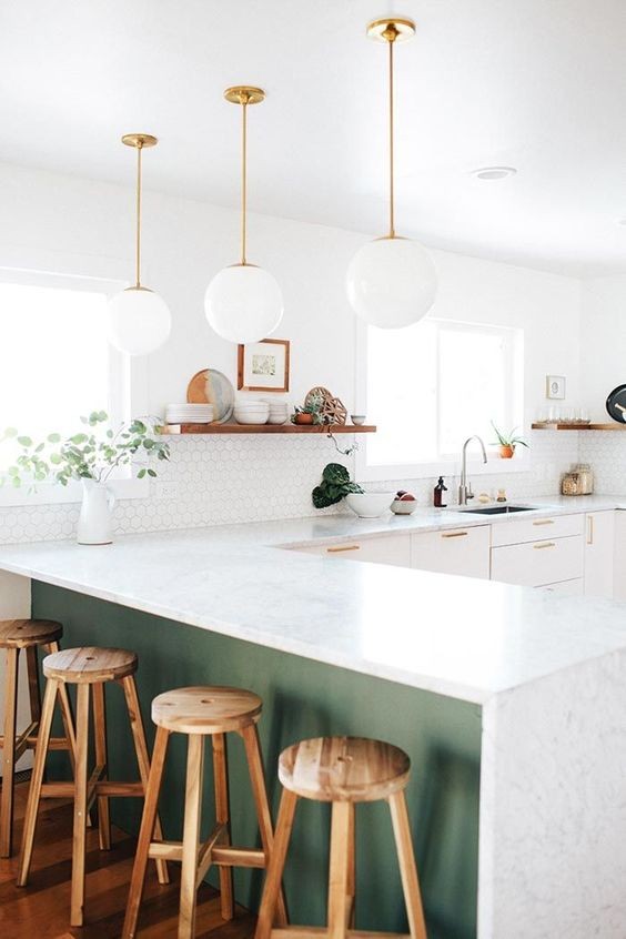 peek of green peninsula kitchen peninsula, pendant lighting, white cabinetry, gold hardware