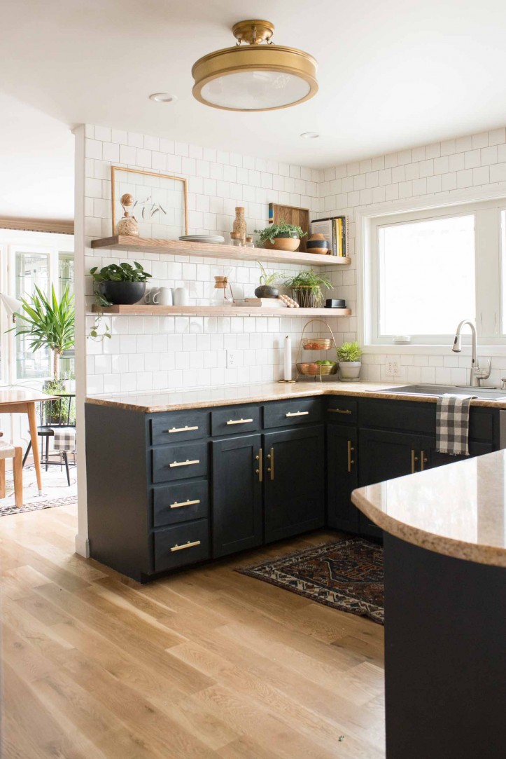 moody u-shaped peninsula kitchen peninsula, dark cabinetry, subway tile, backsplash, light wood floor