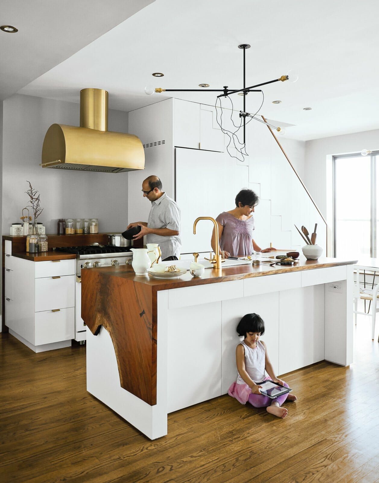 kitchen, waterfall island, live-edge, wood countertops, white cabinets, brass accents, pendant lighting