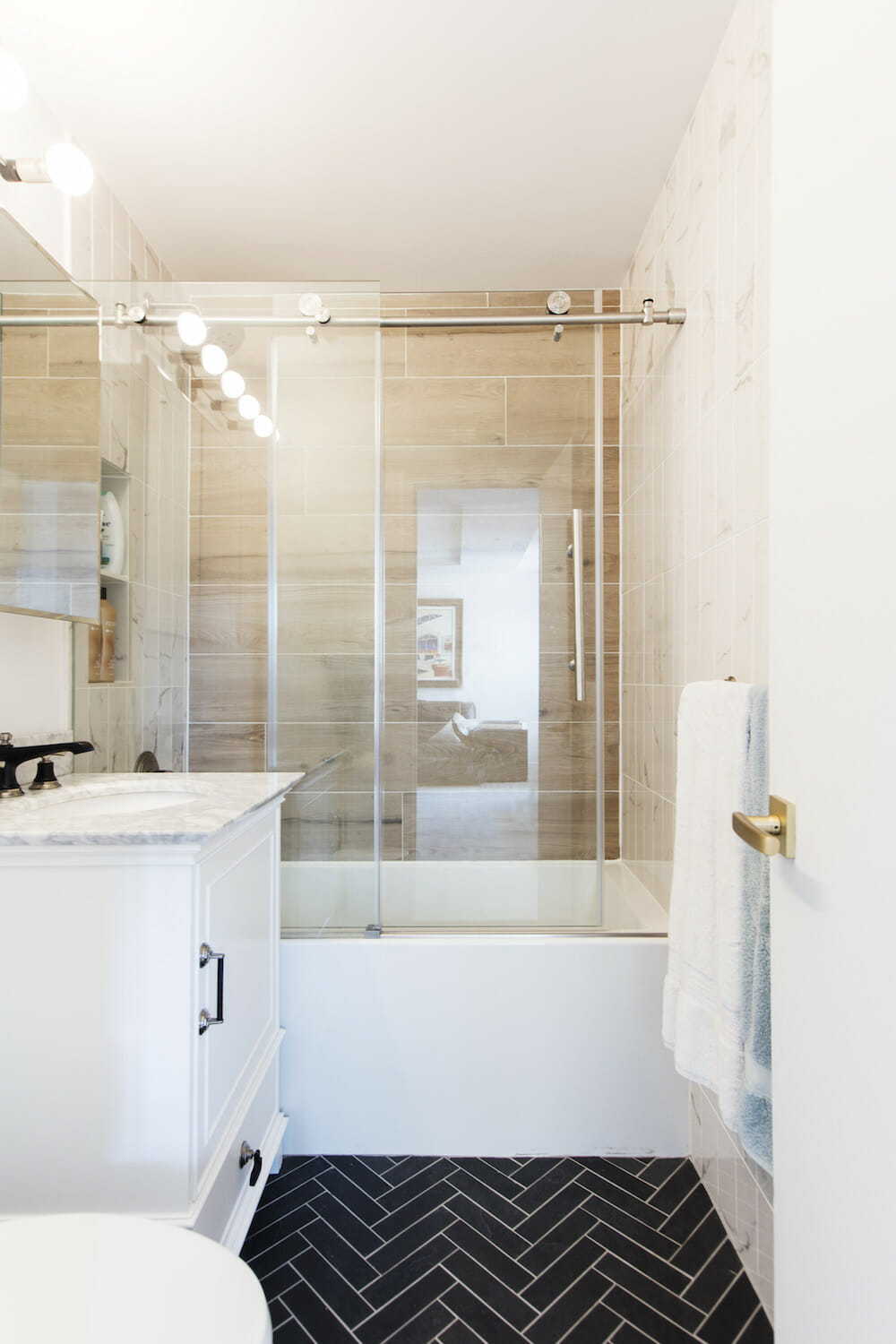 designer renovation, home renovation, bathroom renovation, black and white tile, glass shower door