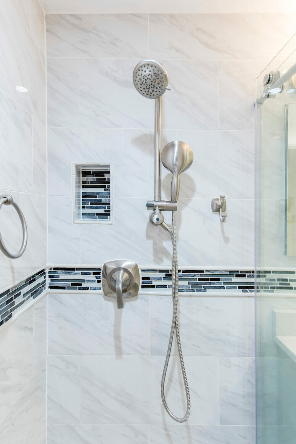 White walk in shower with matte nickel finish bathroom fittings and large showerhead after renovation