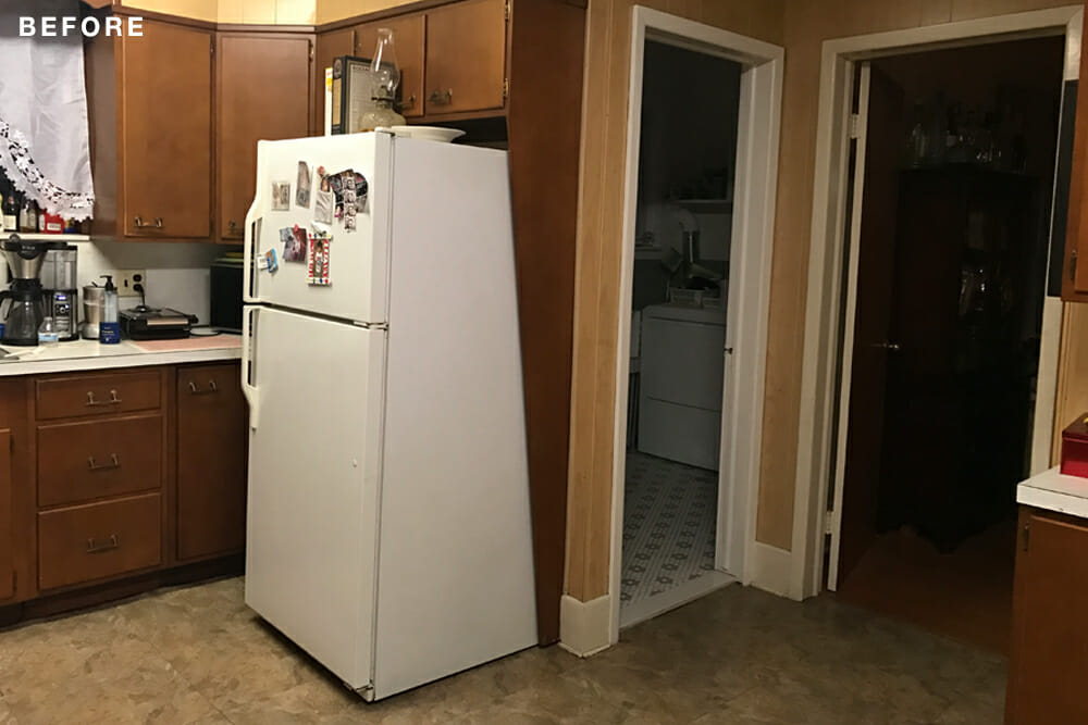 walnut kitchen cabinets and beige wall paint and white appliances before renovation