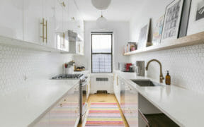 white galley kitchen with open shelf