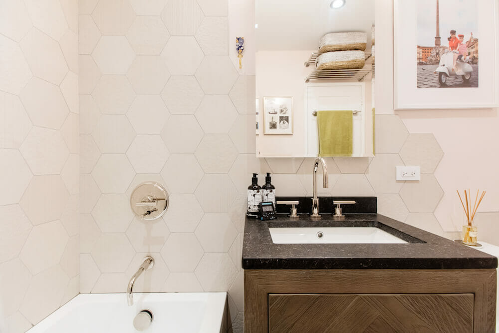 Hexagon tiles in bathroom and herringbone vanity after renovation