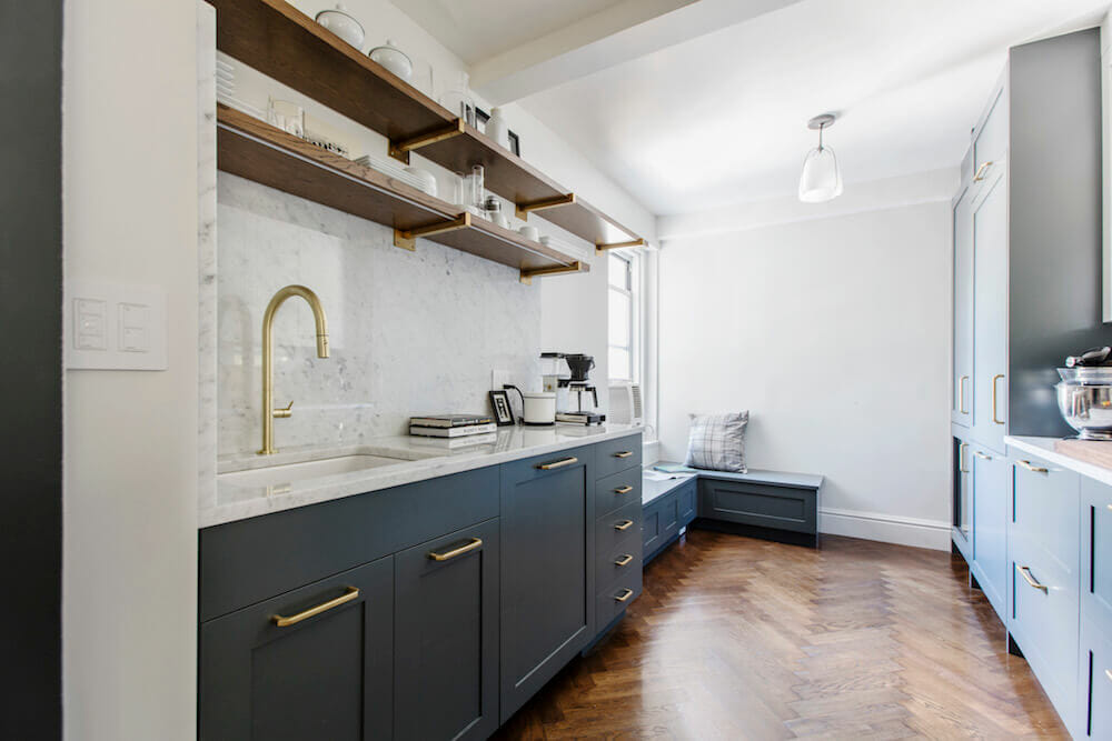 White and gray kitchen with brown wood flooring and open shelves after renovation