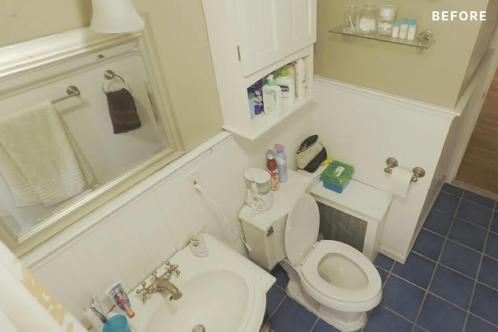 White and beige bathroom with blue floor tiles before renovation