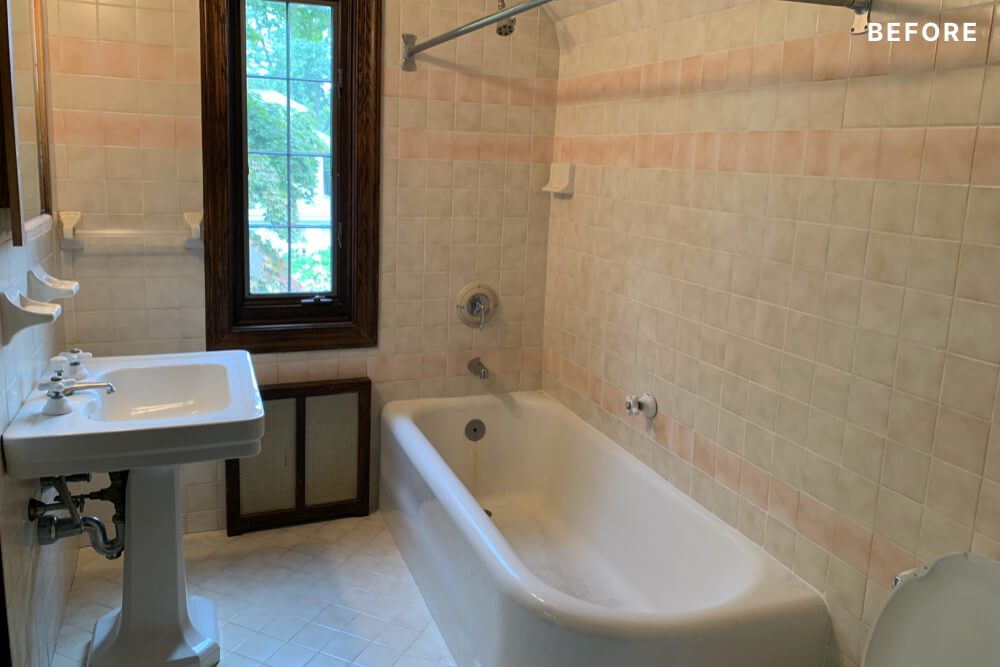 full bath with pedastal sink and window and bathtub and floor to ceiling wall tiles before renovation