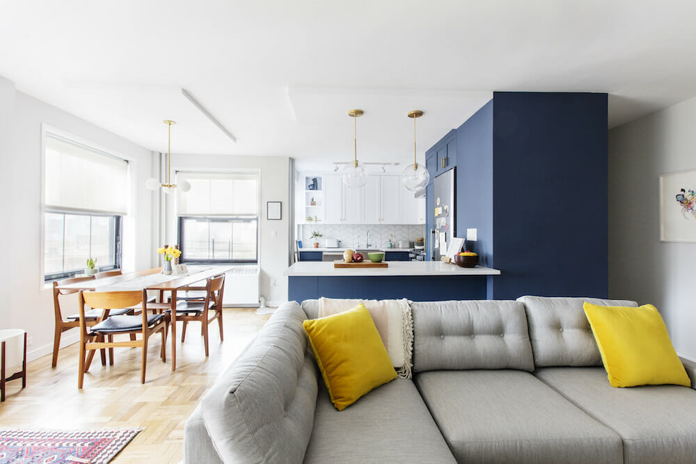 open concept living room and blue kitchen