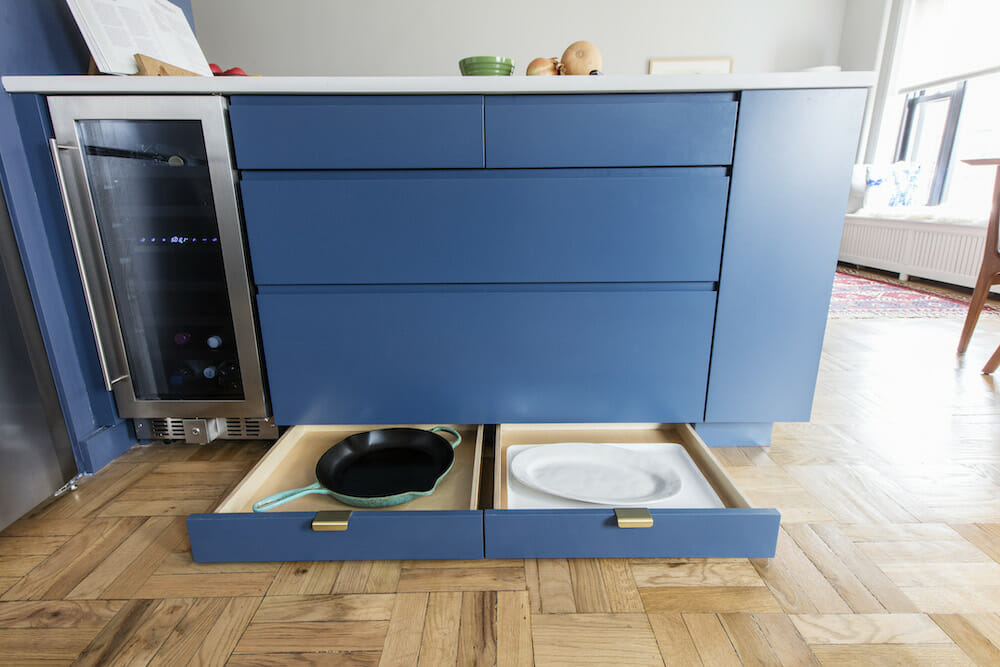 These toe-kick kitchen drawers leave no space wasted in this small city apartment
