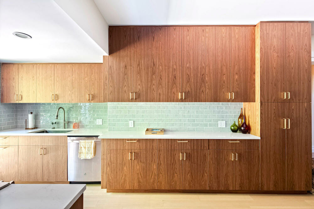 Ceiling-height kitchen cabinets, green backsplash