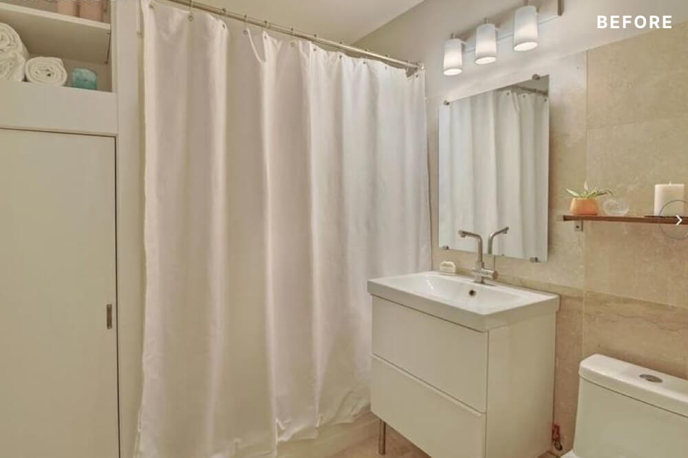 Beige wall tiles with white sink and vanity with white shower curtains before renovation