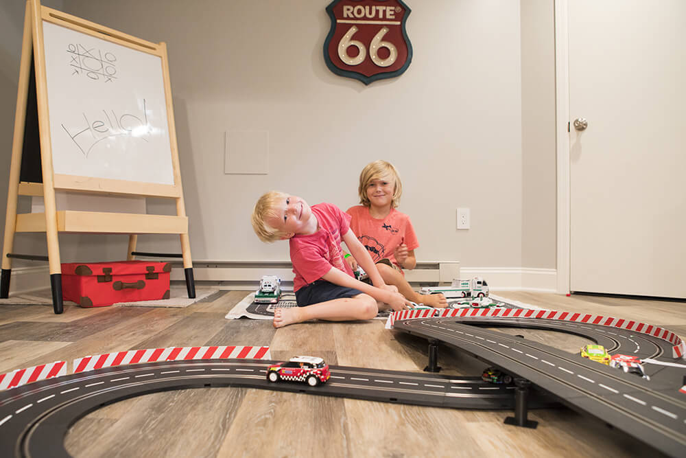 Kids playing on the vinyl floor with toys after renovation