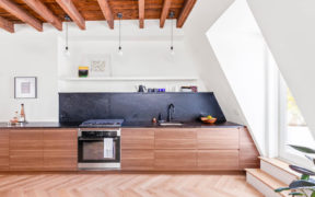 Ikea kitchen with wooden cabinets and slate soapstone countertops